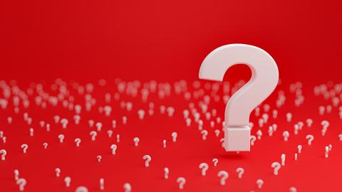 A group of question marks on a red background