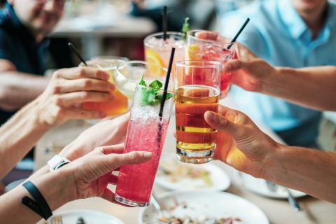 Hands holding coloured drinks