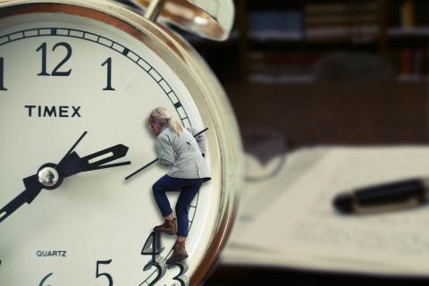 an image of a clock with someone climbing the clockface