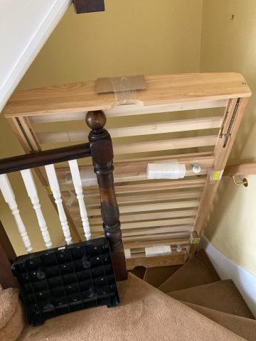 A bedframe stuck on a staircase