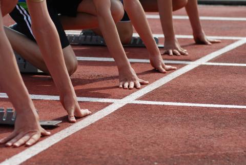 Runners lining up to start a sprint