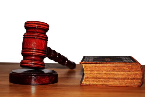 An image of a judge's gavel and a book